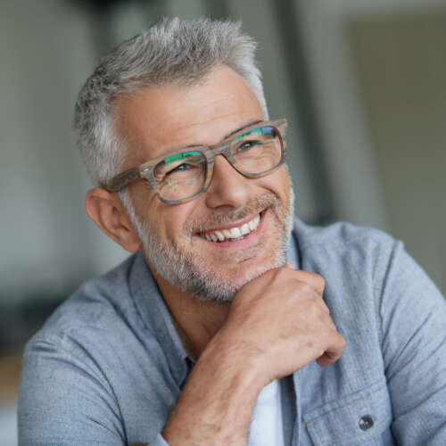 man with glasses smiling