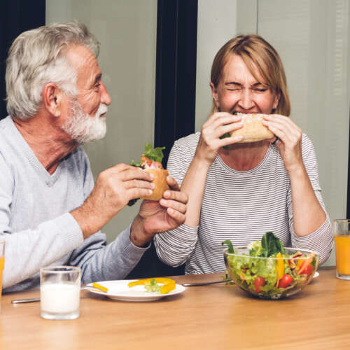 middle age man and woman eating