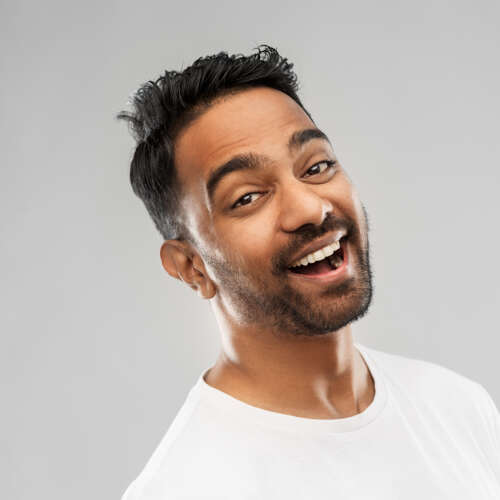 young man smiling with black hair