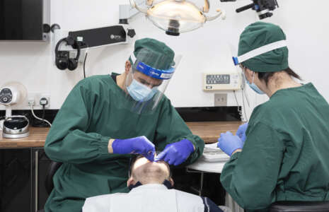 dr nissit patel carrying out dental implant treatment at progressive dentistry