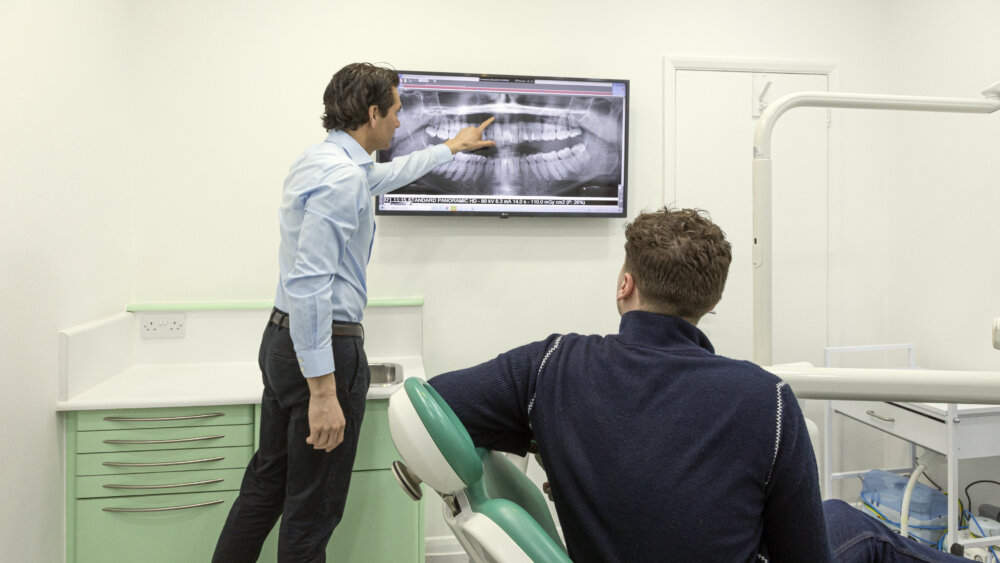 DR Patel looking at teeth straightening slide