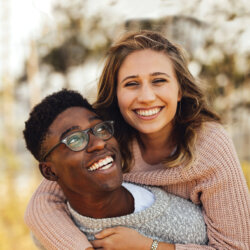 A young couple smiling close up