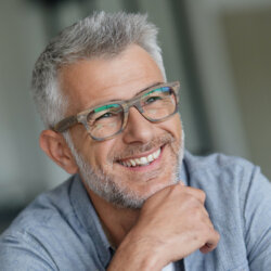 Man with glasses smiling close up
