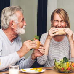 Middle age man and woman eating close up