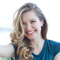 Woman smiling doing selfy on mobile phone close up